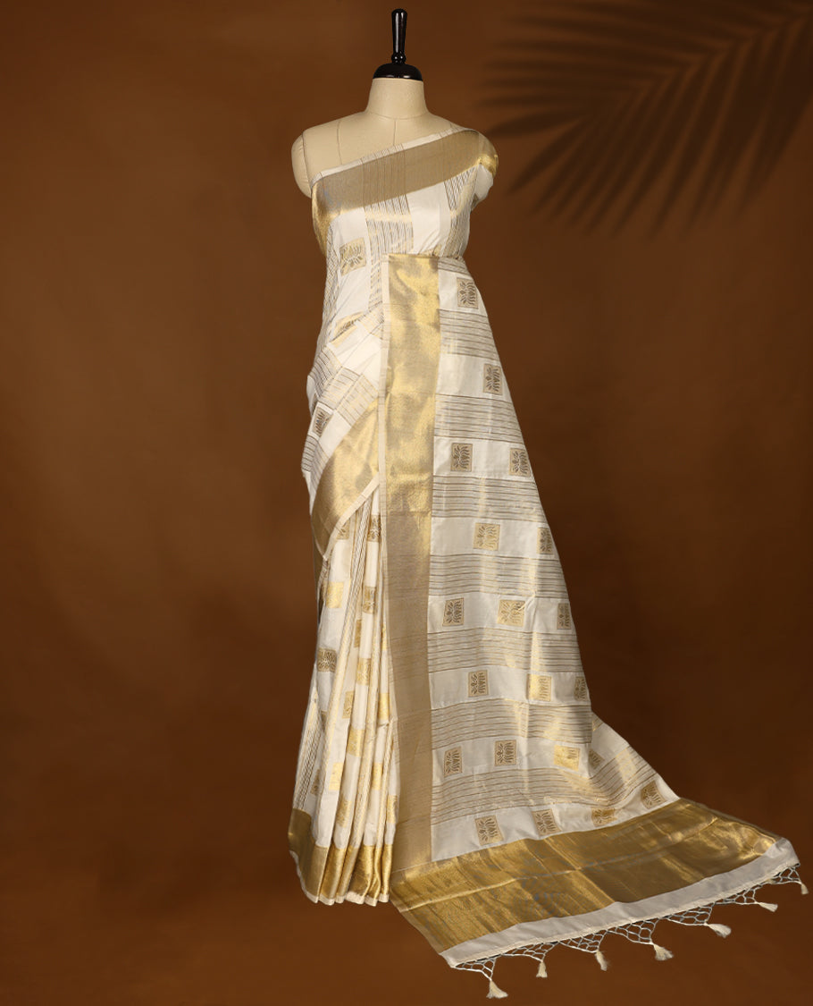 Elegant white colour soft  Tussar Kerala saree featuring Stripes and Lotus detailing on body, Gold kasavu border, Rich Pallu, offering a classic and graceful look, paired with a matching blouse.