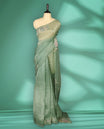 Pastel Green Colour organza saree featuring delicate floral embroidery with applique, bead, mirror, and thread detailing on the body and scalloped border, lending a soft feminine charm, paired with a matching blouse.