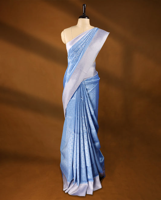 Pastel Blue coloured semi silk saree featuring a Silver coloured Zari design on the body, paired with a Lavender coloured border and blouse.