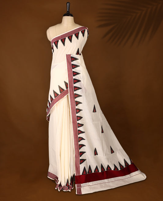 Elegant off white colour cotton Kerala saree featuring Plain body, Maroon colour border with temple designs, Paired with matching blouse offering a classic and graceful look, paired with a matching blouse.