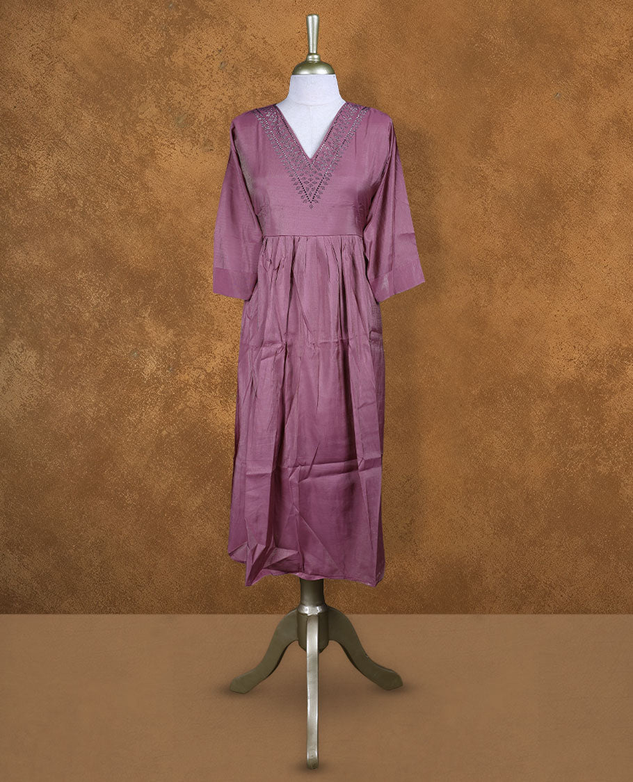Dark mauve colour kurti highlighted with dainty cutwork along the V-neck yoke, styled with gentle gathers at the waist and comfy 3/4th sleeves.