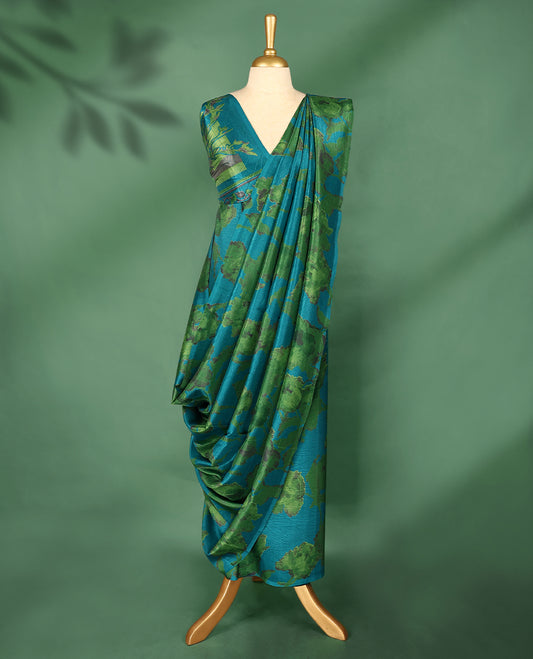 Teal blue colour Manipuri saree features a body with abstract leafy patterns in shades of green, without border, and comes with a matching blouse.