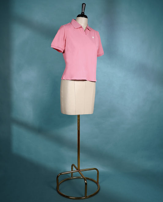 Soft pink polo neck top with short sleeves and a waist length cut, perfect for everyday wear.