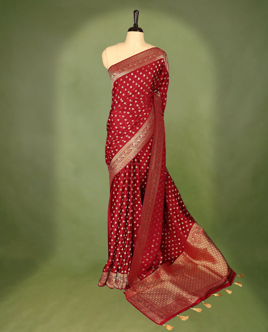 Chilli Red  semi-Banaras satin crepe saree featuring traditional closely woven buttas on the body, complemented by an antique-style border and a matching self-coloured blouse.