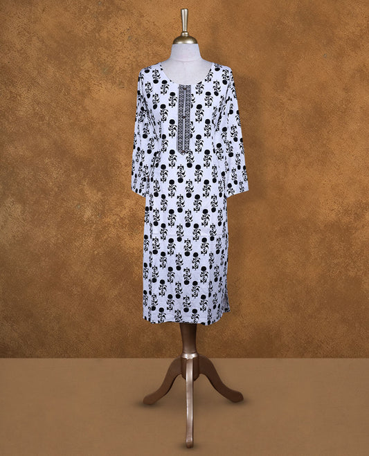 White and black colour kurti with black floral prints, knee length design, styled with a round neckline and a sleeve .