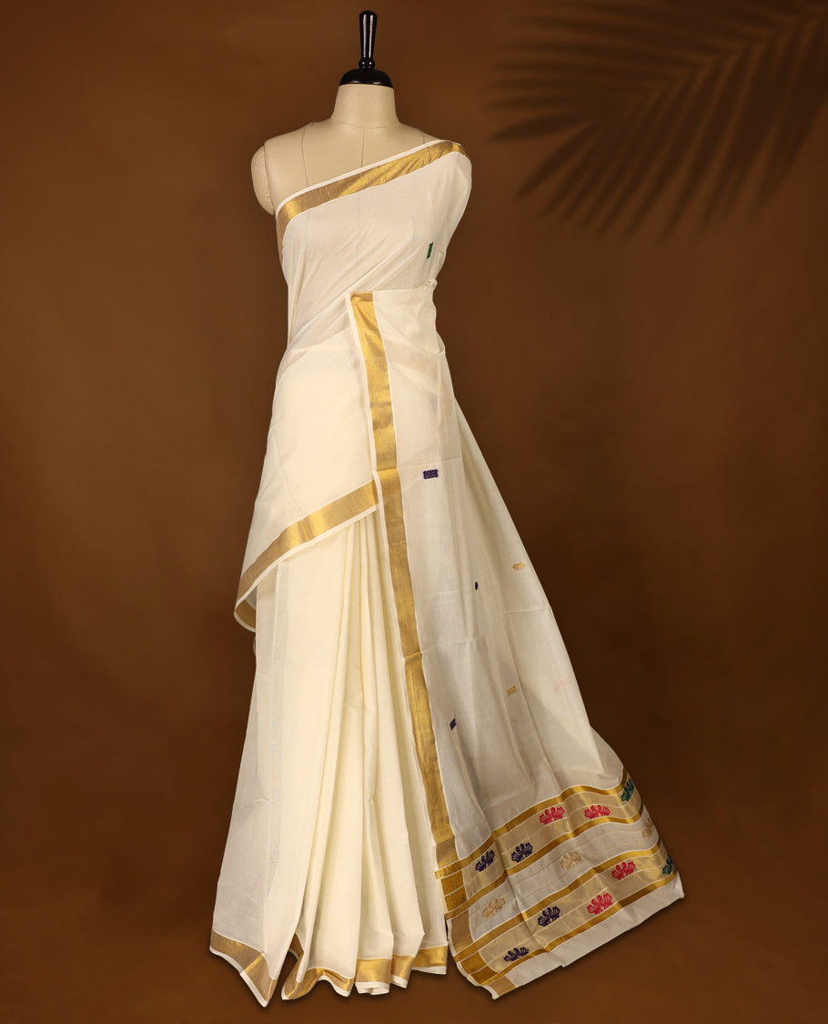 Elegant off white colour cotton Kerala saree featuring Plain body and traditional golden zari kasavu border with multi colour Double peacock Embroidery offering a classic and graceful look, paired with a matching blouse.