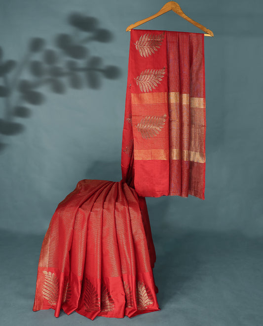 Red Colour Semi Tussar Silk saree featuring golden zari horizontal lines across the body, adorned with bold Leaf motifs on the border, paired with a matching blouse.