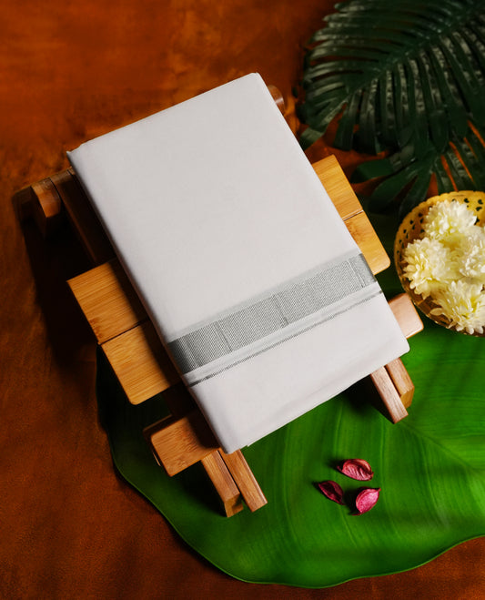 White colour cotton single dhoti featuring a silver border with elegant stripe detailing & Designed for daily comfort and traditional grace, ideal for rituals, cultural events, and festive wear.