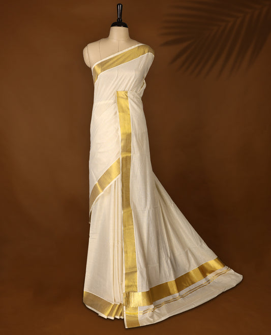 Elegant off white colour cotton Kerala saree featuring gold Zari Striped body, gold zari traditional kasavu border offering a classic and graceful look, paired with a matching blouse.