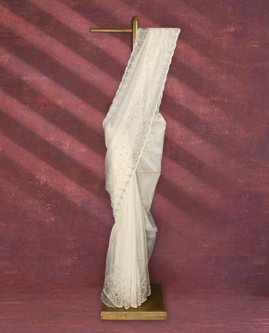 White colour pure organza saree featuring sequin work all over the body, adorned with a heavily embellished border with beads, stones, and sequins, complemented by a worked pallu and paired with a matching embellished blouse