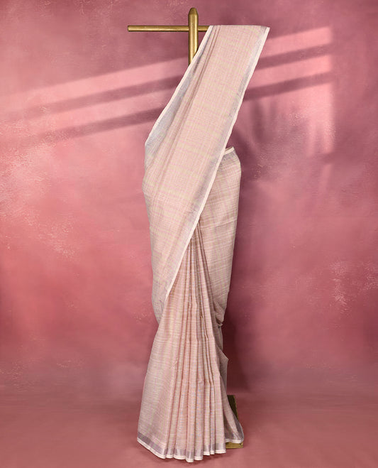 Soft blush pink colour pure linen saree featuring a striped design on the body, crafted in lightweight and breathable fabric for everyday comfort, enhanced with a simple and elegant border, paired with a matching blouse