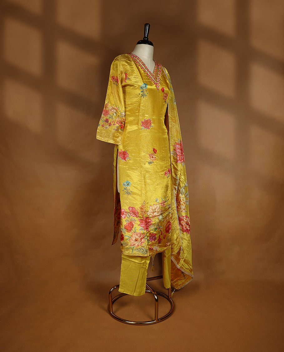 Mustard yellow colour salwar from TWARA, featuring a V-neck adorned with cut beads, sequins, and thread work, with digital floral prints on the top, paired with a matching bottom and a digital printed dupatta.