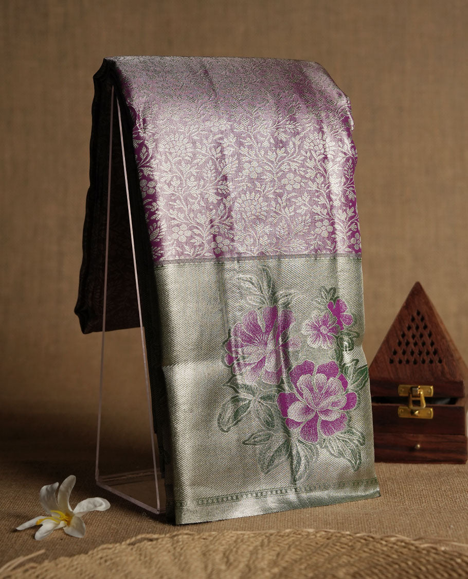 Purple colour and Antique silver Zari Tissue Brocade Saree features intricate floral Motifs on body and pastel green colour fancy border & pallu with purple floral patterns, paired with matching blouse