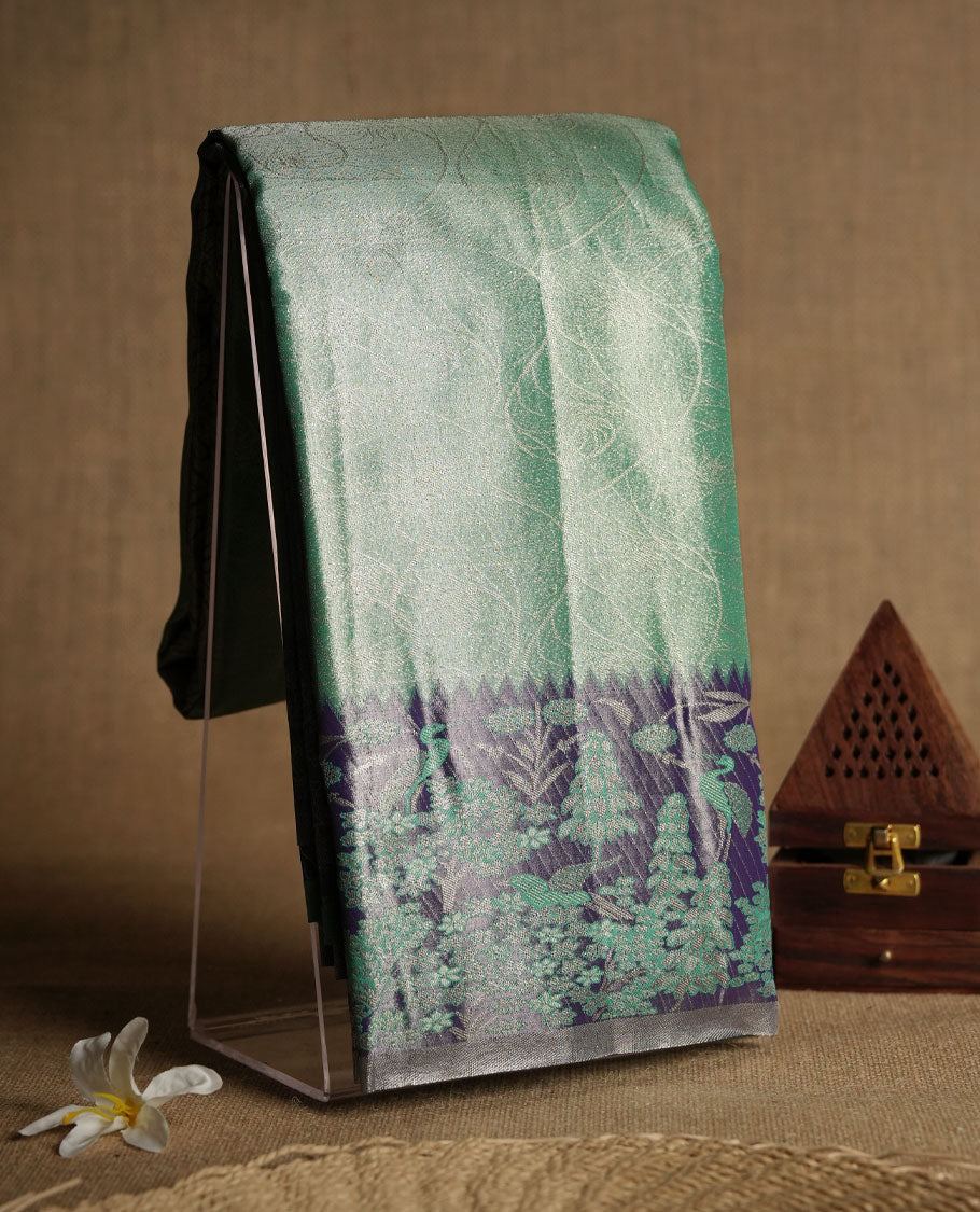 Aqua green colour and Antique gold Zari Tissue Brocade Saree features intricate Motifs on body and pastel purple colour fancy border & pallu with forest patterns, paired with matching blouse