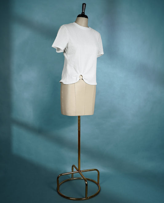 White textured short sleeve top featuring a crew neck and a front ring detail for a subtle, stylish twist.