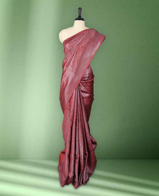 Brick Red colour semi silk saree featuring neem zari floral kodi motifs all over the body, complemented by a rich self colour woven border, with matching blouse.