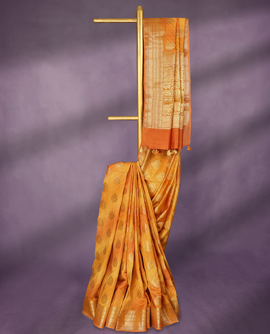 Mustard colour pure Banarasi Chanderi cotton, beautifully enhanced with hand-brushed colour and traditional antique zari butta motifs across the body, paired with traditional border and a matching blouse.