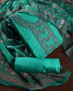 Teal green churidhar material featuring a printed top with delicate floral vine motifs, paired with a floral bordered dupatta and plain bottom & A perfect blend of elegance and comfort for festive and casual wear.