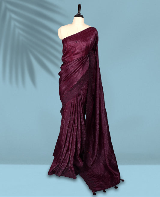 Maroon Colour crush soft silk saree, textured body with a natural crinkled finish, adorned with intricate self colored floral Motifs and complemented by a delicate thread embroidery cutwork border, paired with a matching blouse