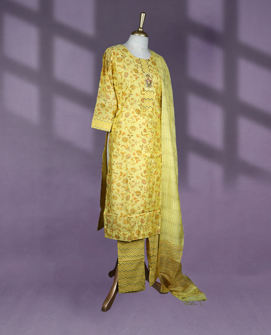 Sunshine yellow colour kurti set featuring a round neckline, three-quarter sleeves, floral and chevron block prints, paired with matching printed pants and a striped dupatta with chevron border accents.