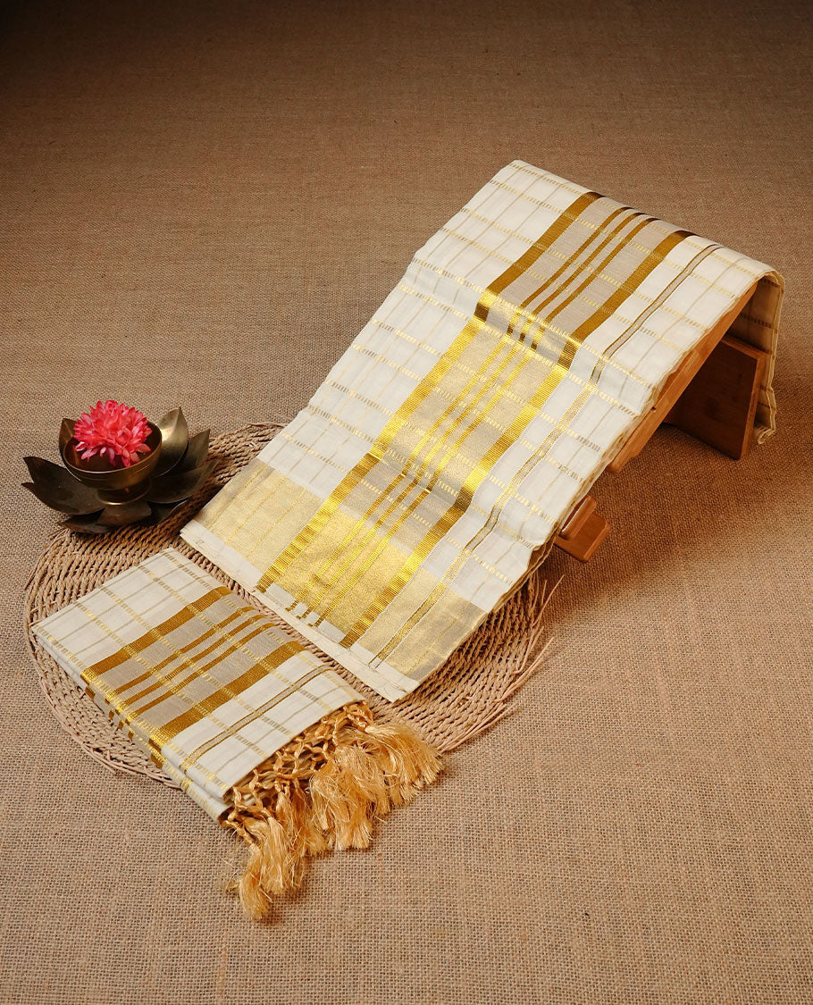 Off white colour Cotton Set Mund featuring self-woven stripe checks, enhanced with a broad traditional gold zari kasavu border and golden tassels.