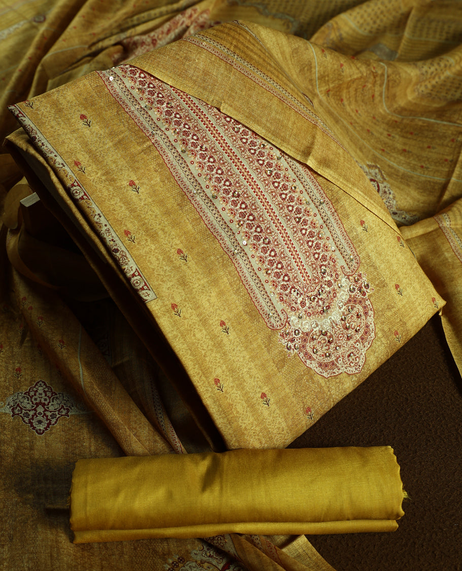 Mustard colour churidhar material with elegant maroon embroidery and delicate motifs, complemented by a plain matching bottom and dupatta.