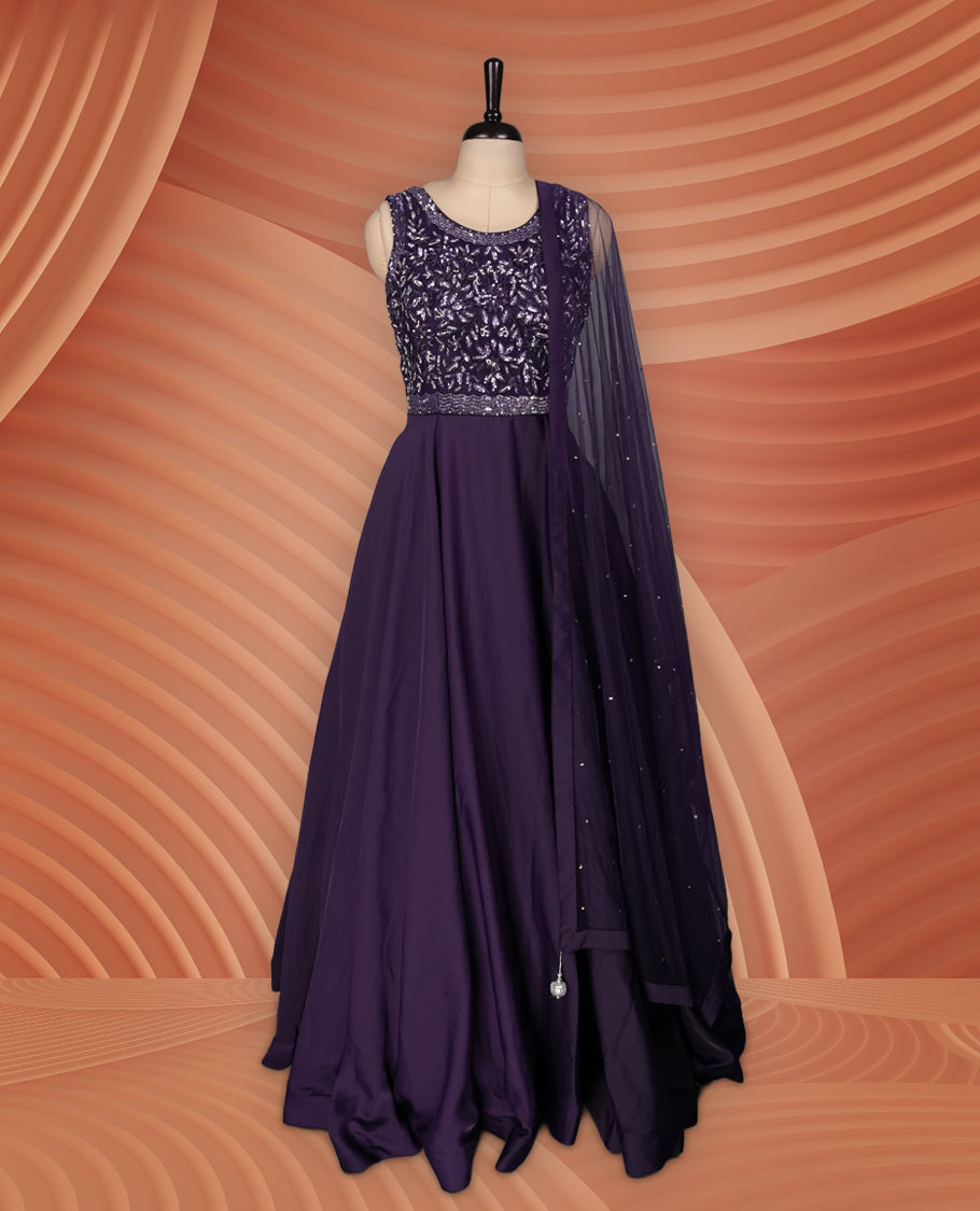 Graceful deep purple gown with a sleeveless sequin-embroidered bodice, flowing flared skirt, and a matching sheer dupatta adorned with delicate embellishments, ideal for parties and festive occasions.