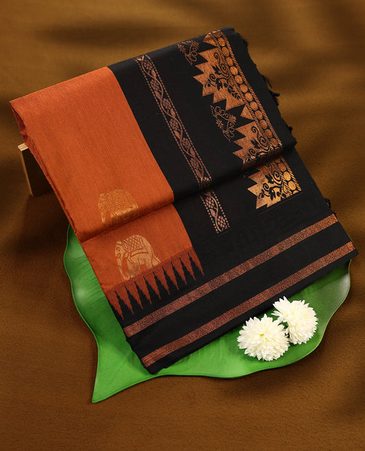 Rust Orange colour mixed Kalyani cotton saree featuring copper zari motifs throughout the body, paired with Pure Black colour traditional border and pallu, with matching blouse
