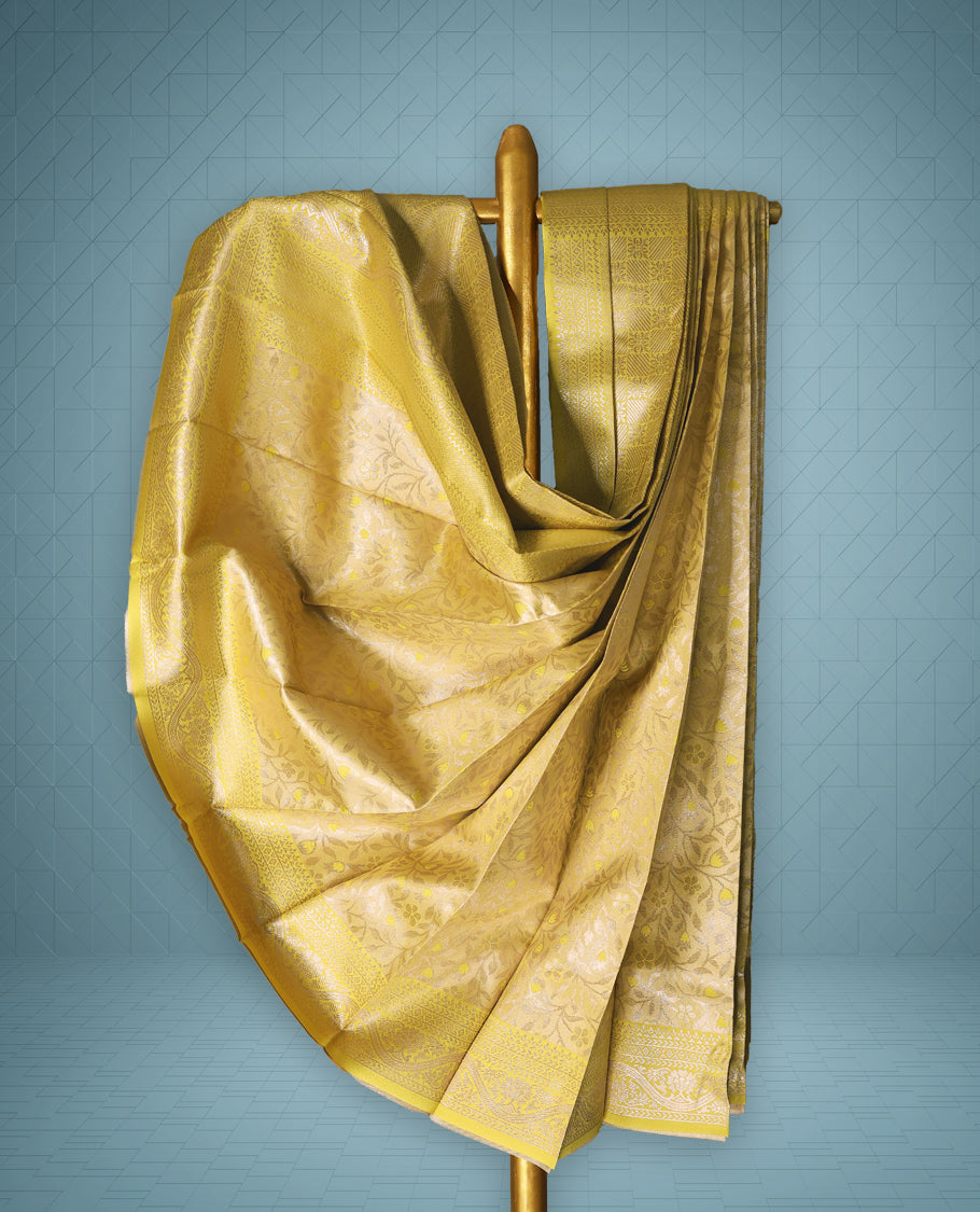 Pastel Yellow Semi tissue saree featuring a brocade body, self coloured zari border, and a matching self coloured blouse.