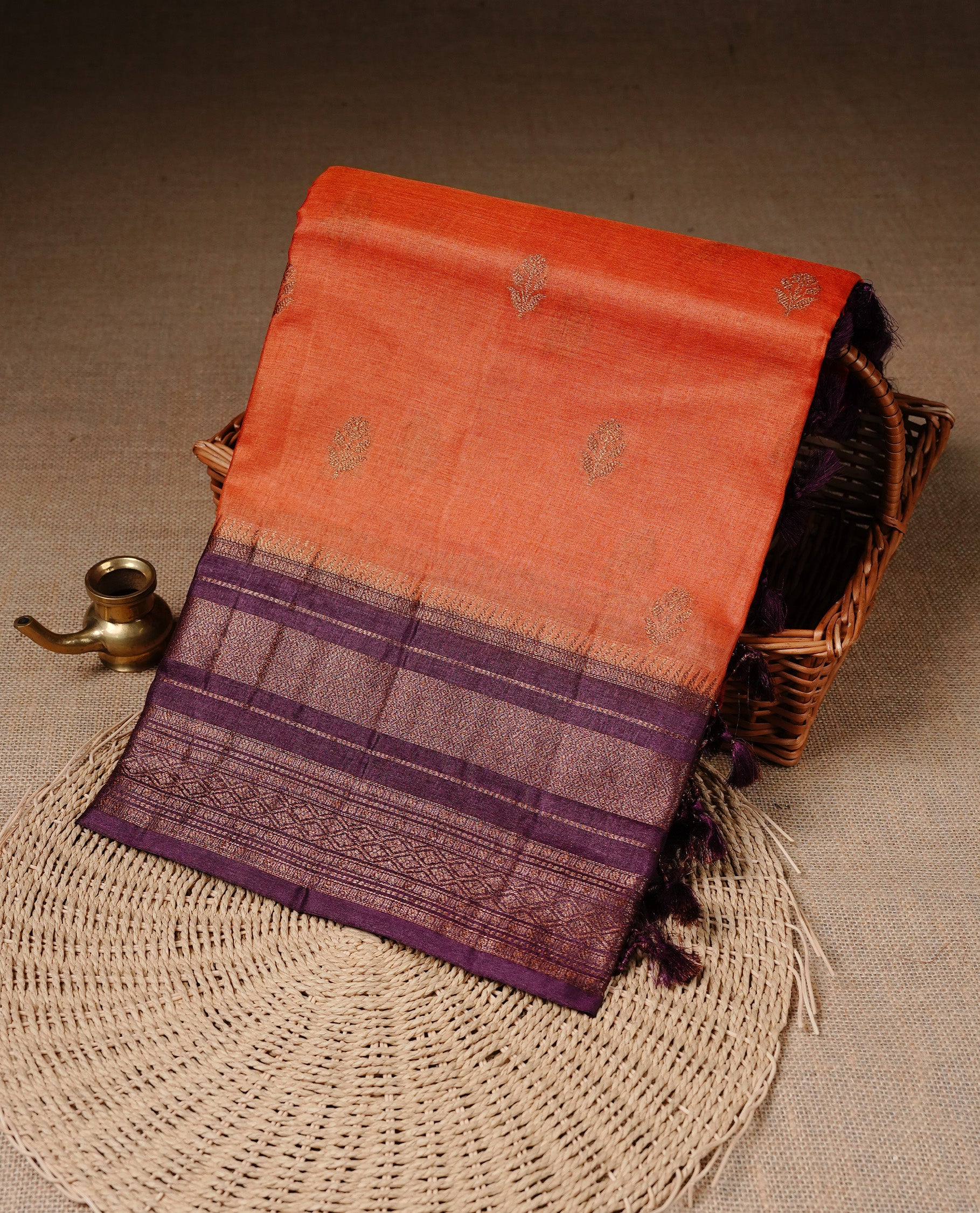 Orange colour Pure Banaras Tussar silk saree Featuring Gold zari buttas on body, complemented by Contrast Burgundy colour with zari border, paired with matching blouse piece.