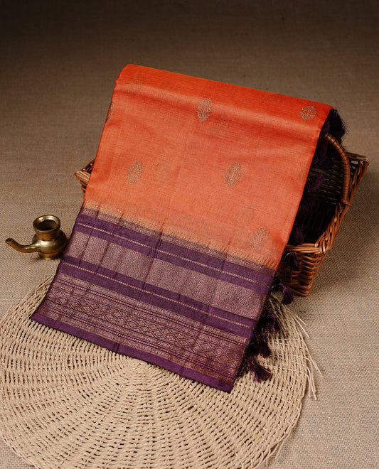 Orange colour Pure Banaras Tussar silk saree Featuring Gold zari buttas on body, complemented by Contrast Burgundy colour with zari border, paired with matching blouse piece.