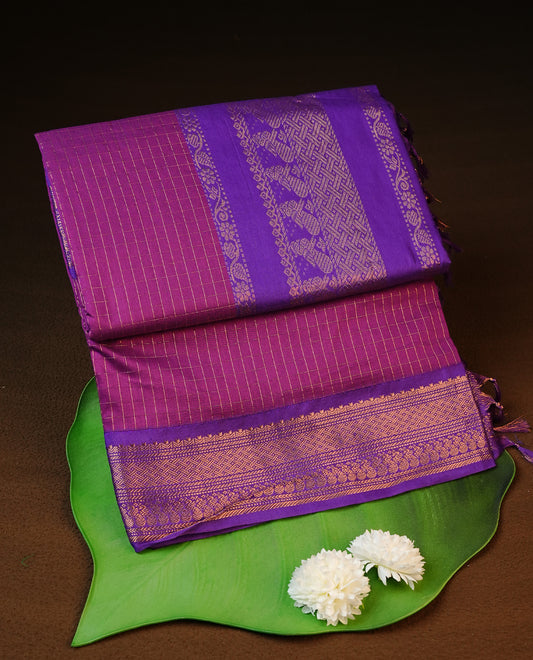 Purple colour kalyani cotton saree featuring gold zari check pattern on body, complemented by Violet colour with Antique zari border, paired with matching blouse piece.