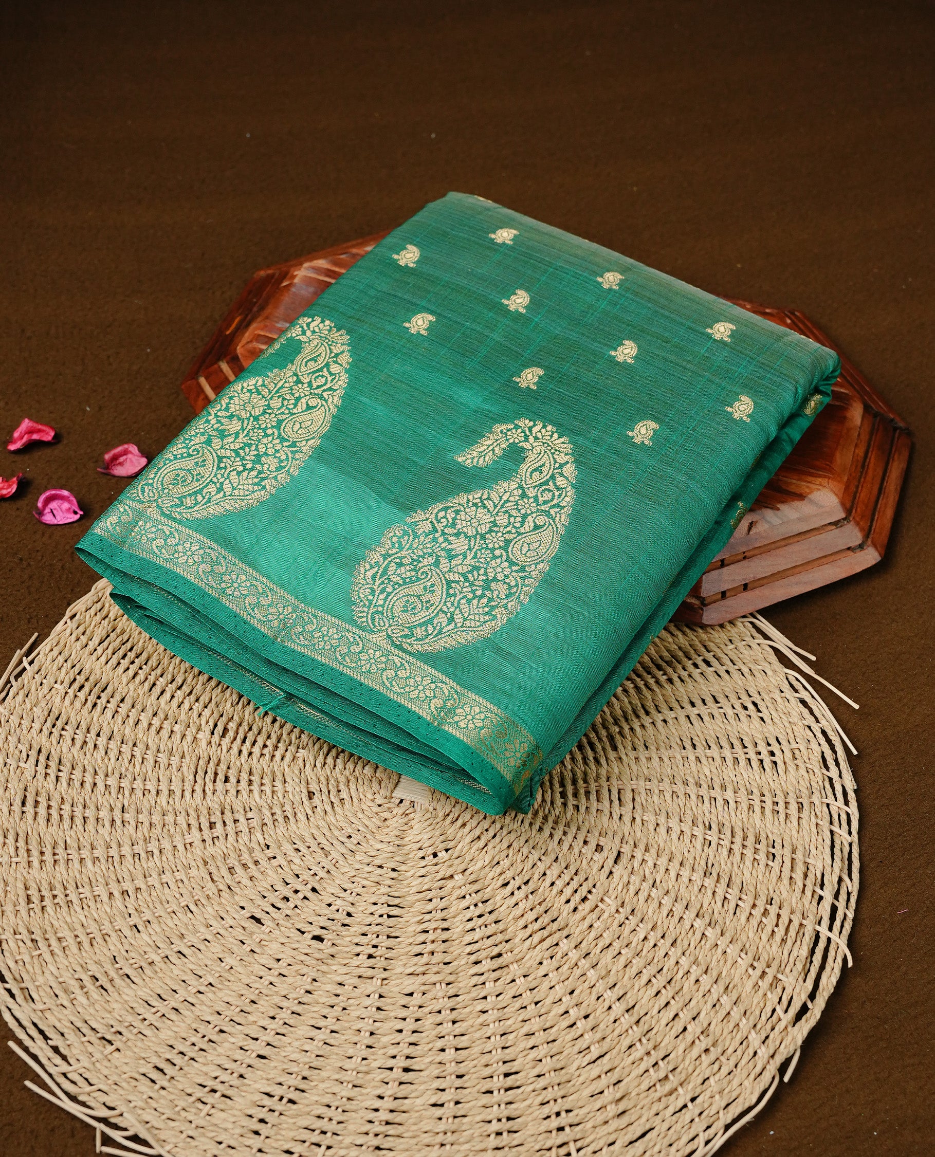 Green colour semi tussar silk saree featuring small gold zari mango motifs across the body, enhanced with a self colour border showcasing elegant gold zari mango patterns. Paired with a matching blouse piece.
