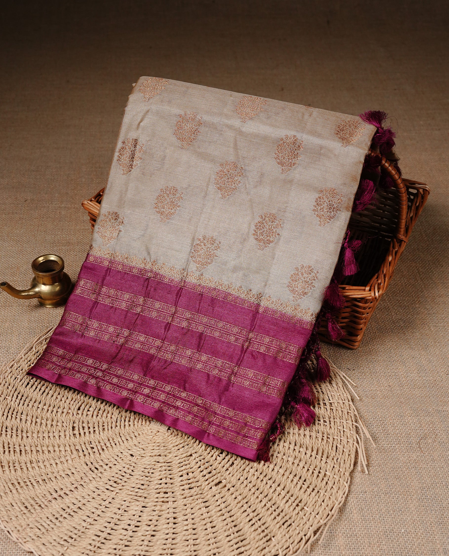Golden Cream Colour Banaras tussar silk saree featuring Antique zari Motifs on body, Complemented by Magenta colour variant with zari border, paired with matching blouse Piece.