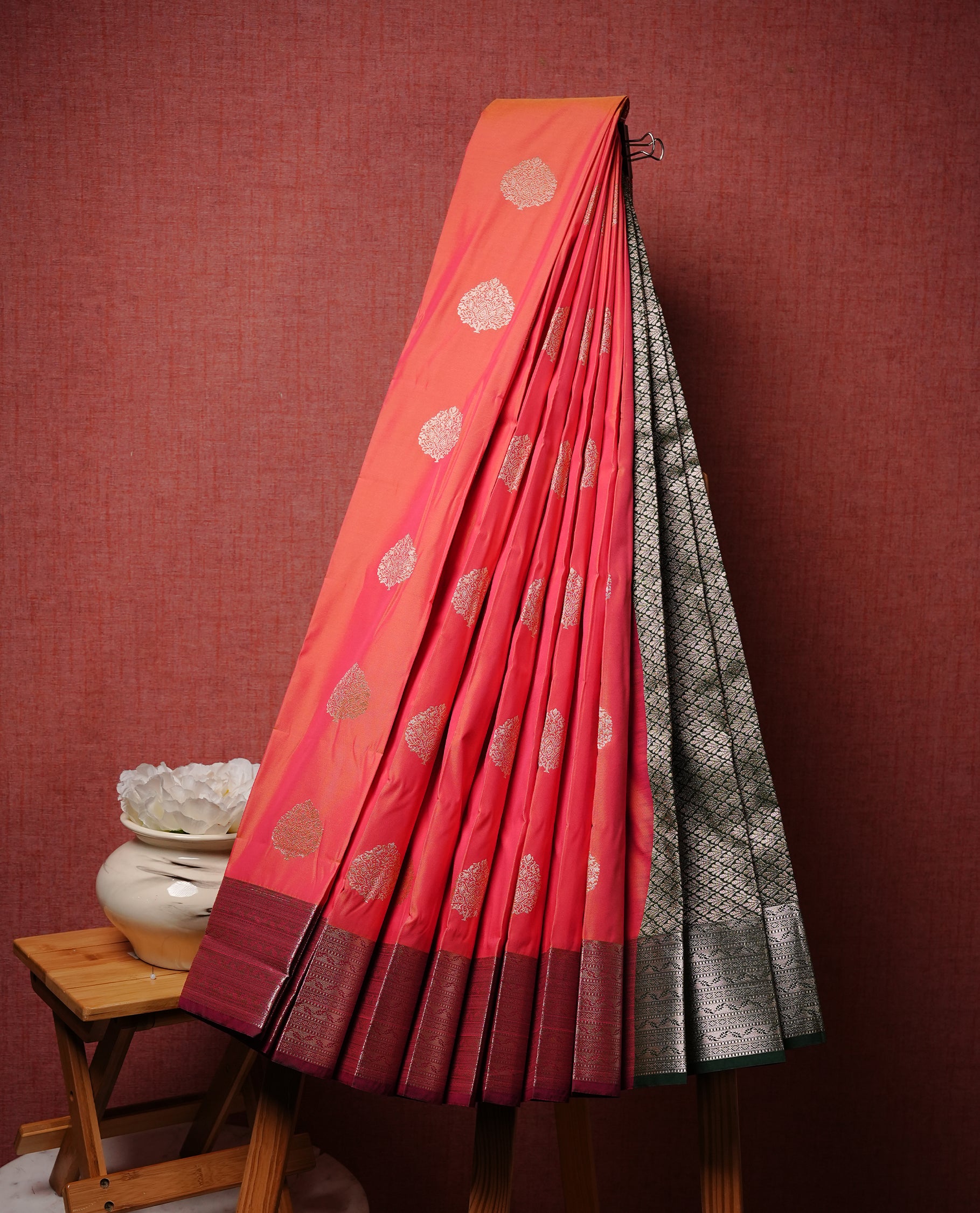 Red colour Semi silk saree Featuring gold zari motifs on body, complemented by contrast maroon colour with gold zari border, paired with matching blouse piece.
