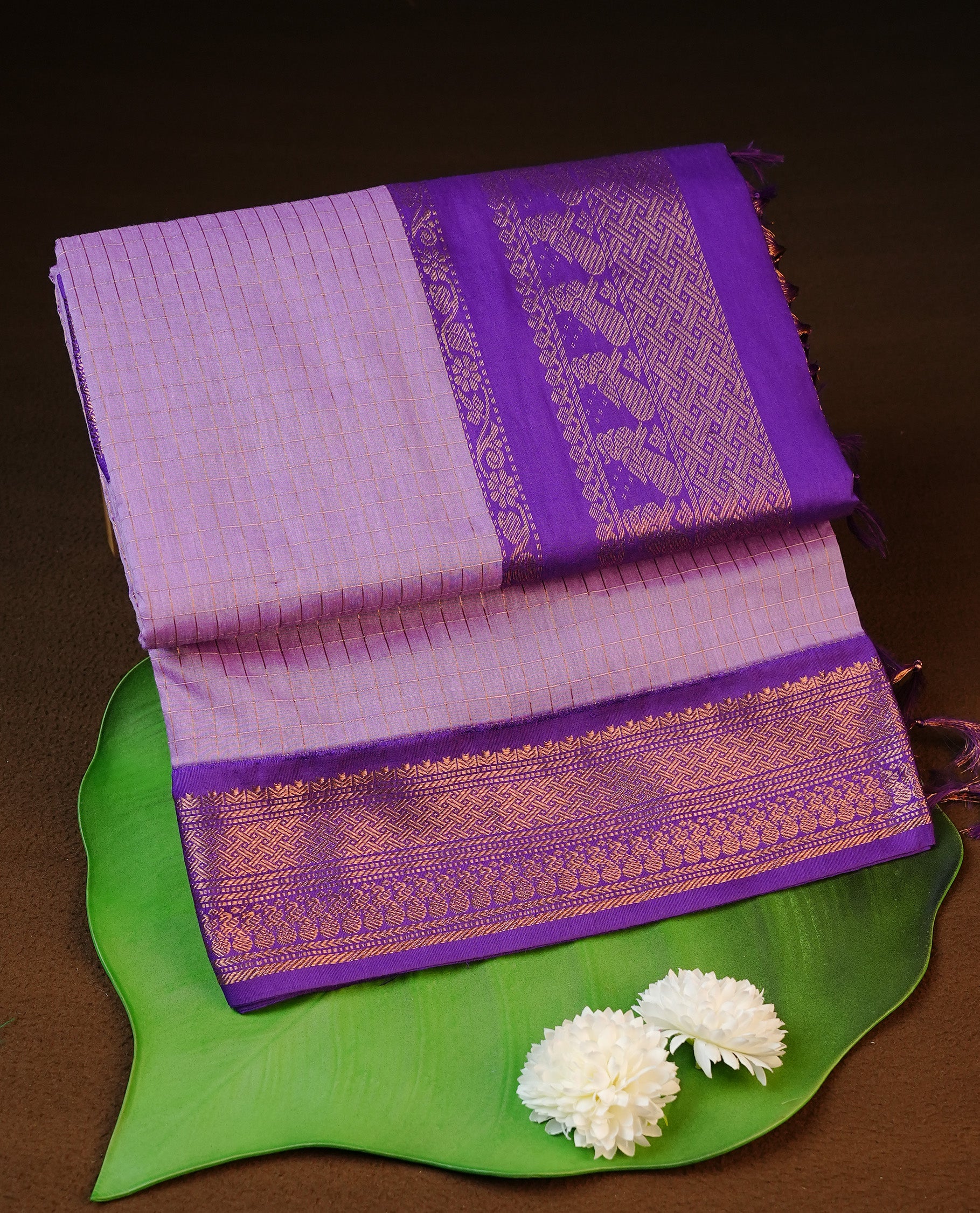 Lavender colour kalyani cotton saree featuring gold zari check pattern on body, complemented by Violet colour with Antique zari border, paired with matching blouse piece.
