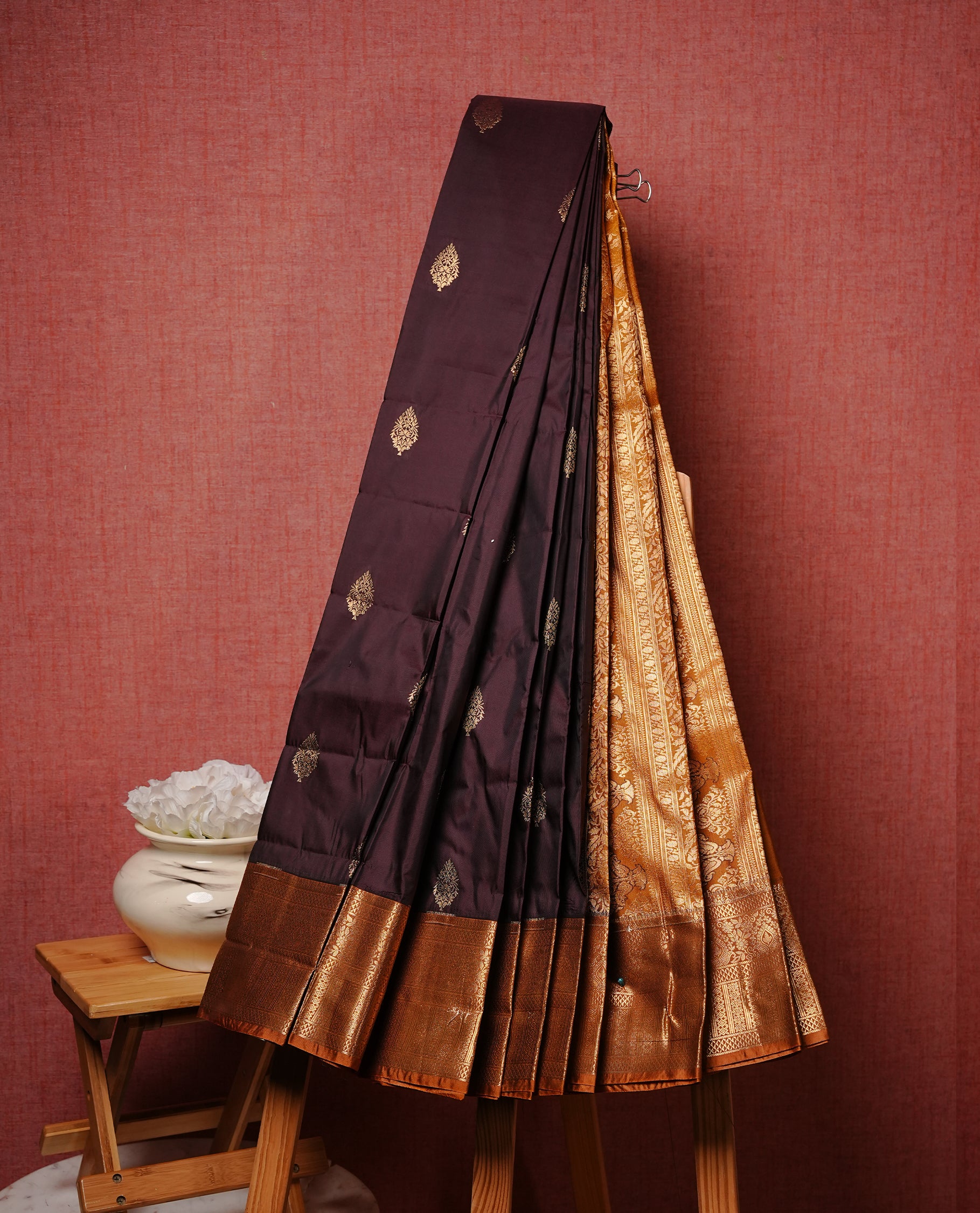 Dark chocolate colour Semi silk saree Featuring gold zari motifs on body, complemented by contrast Mustard colour with gold zari border, paired with matching blouse piece.