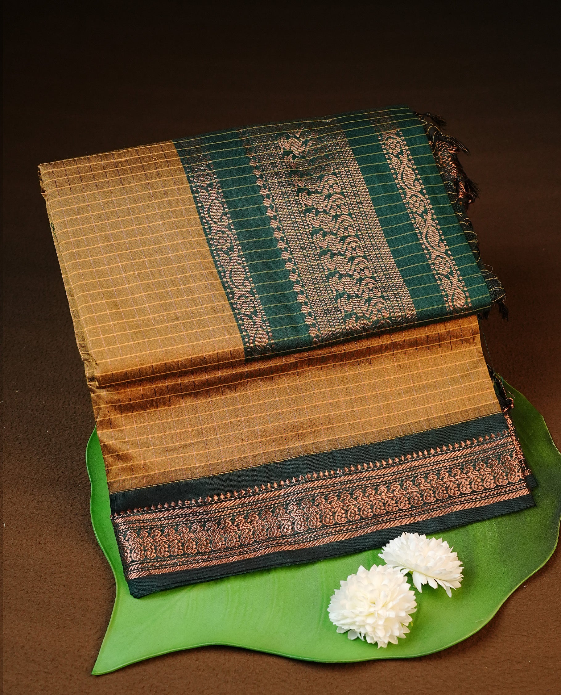 Mustard colour kalyani cotton saree featuring gold zari check pattern on body, complemented by green colour with Antique zari border, paired with matching blouse piece.
