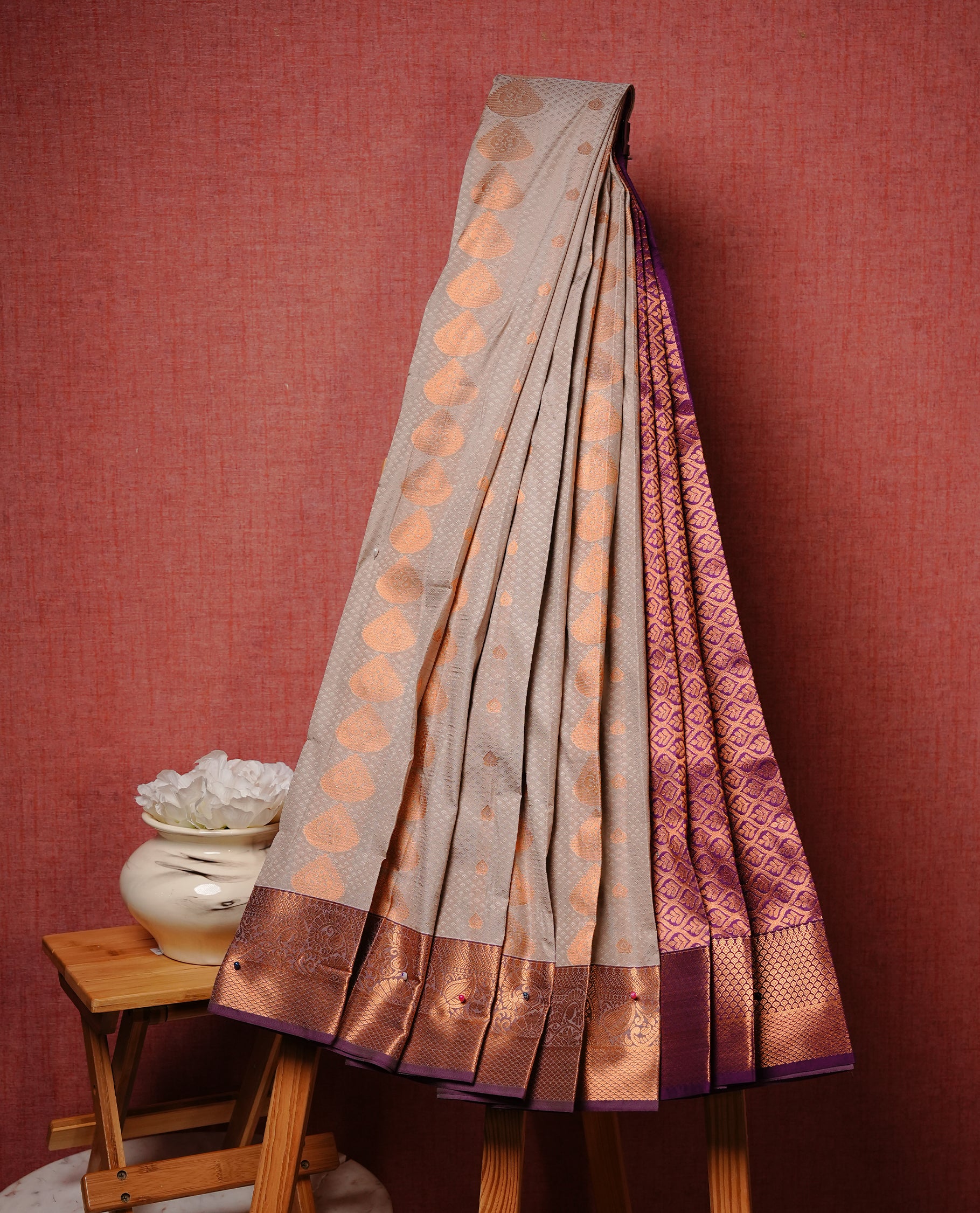 Grey colour Semi silk saree Featuring gold zari motifs on body, complemented by contrast Purple colour with gold zari border, paired with matching blouse piece.