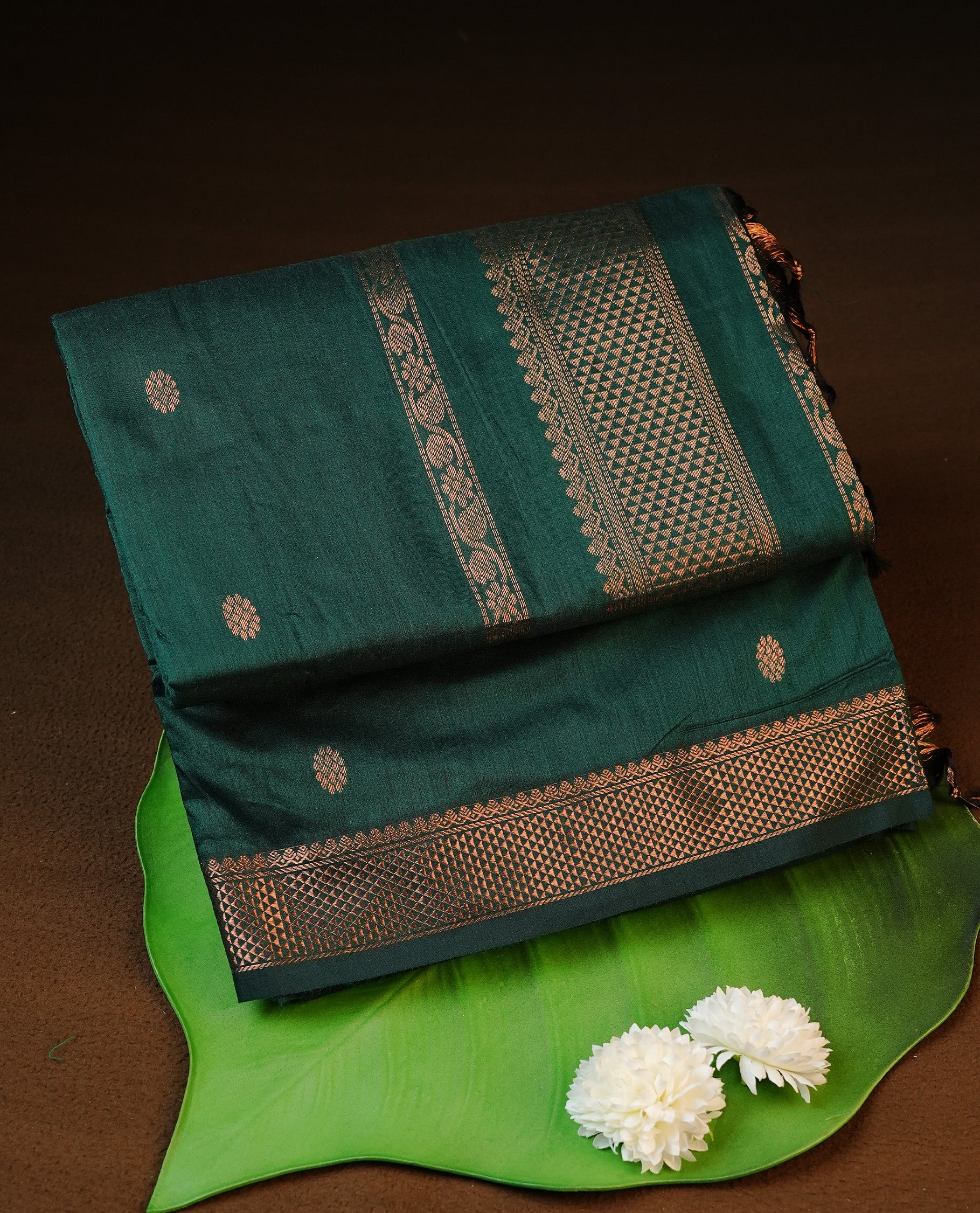 Green colour kalyani cotton saree featuring antique zari motifs on body, complemented by Self colour with Antique zari border, paired with matching blouse piece.