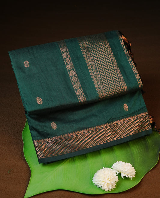 Green colour kalyani cotton saree featuring antique zari motifs on body, complemented by Self colour with Antique zari border, paired with matching blouse piece.