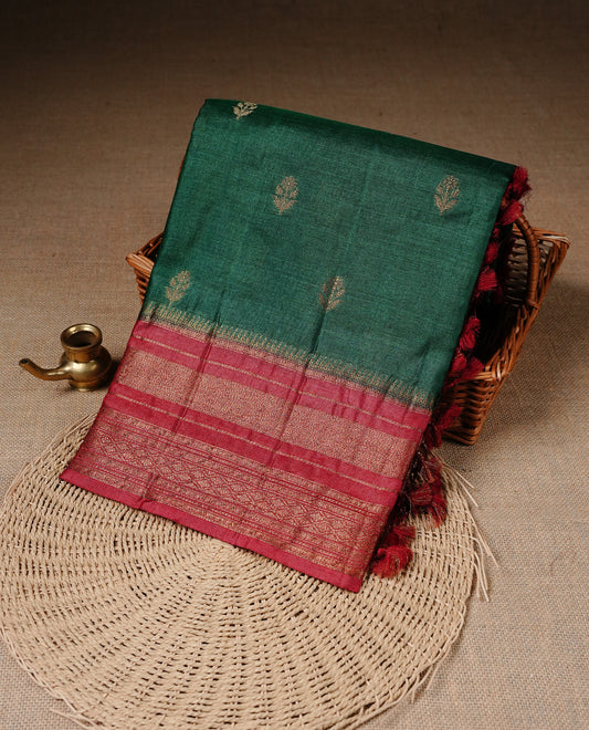 Green colour Pure Banaras Tussar silk saree Featuring Gold zari buttas on body, complemented by Contrast Red colour with zari border, paired with matching blouse piece.