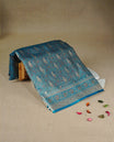 Teal colour Mulberry silk saree featuring gold zari Mango & floral kodi pattern across body, complemented by self colour border with gold zari work, comes with matching blouse piece.