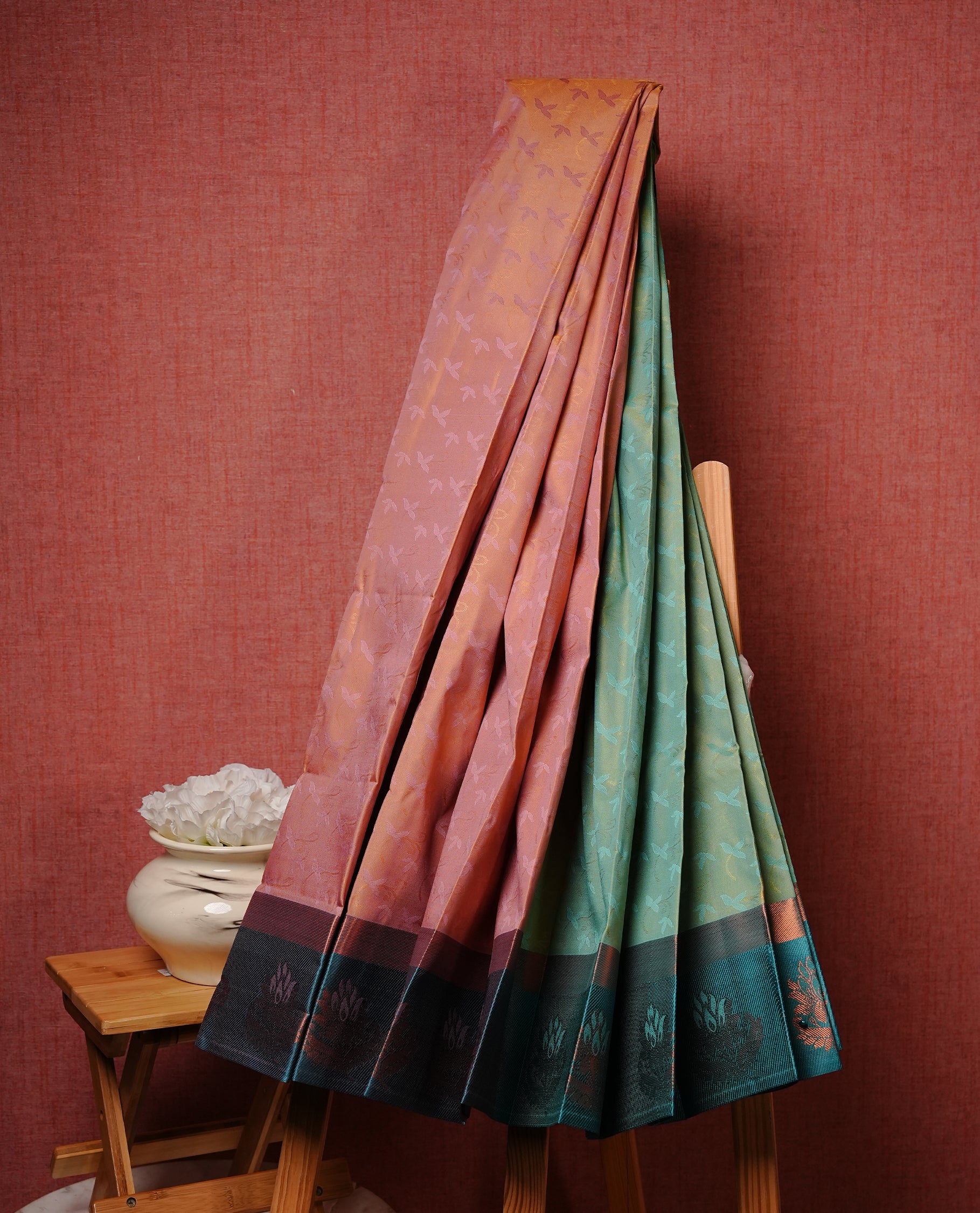 Sandalwood colour Semi silk saree featuirng Cream colour patterns on body, complemented by contrast Green colour with gold zari border, paired with matching blouse piece.