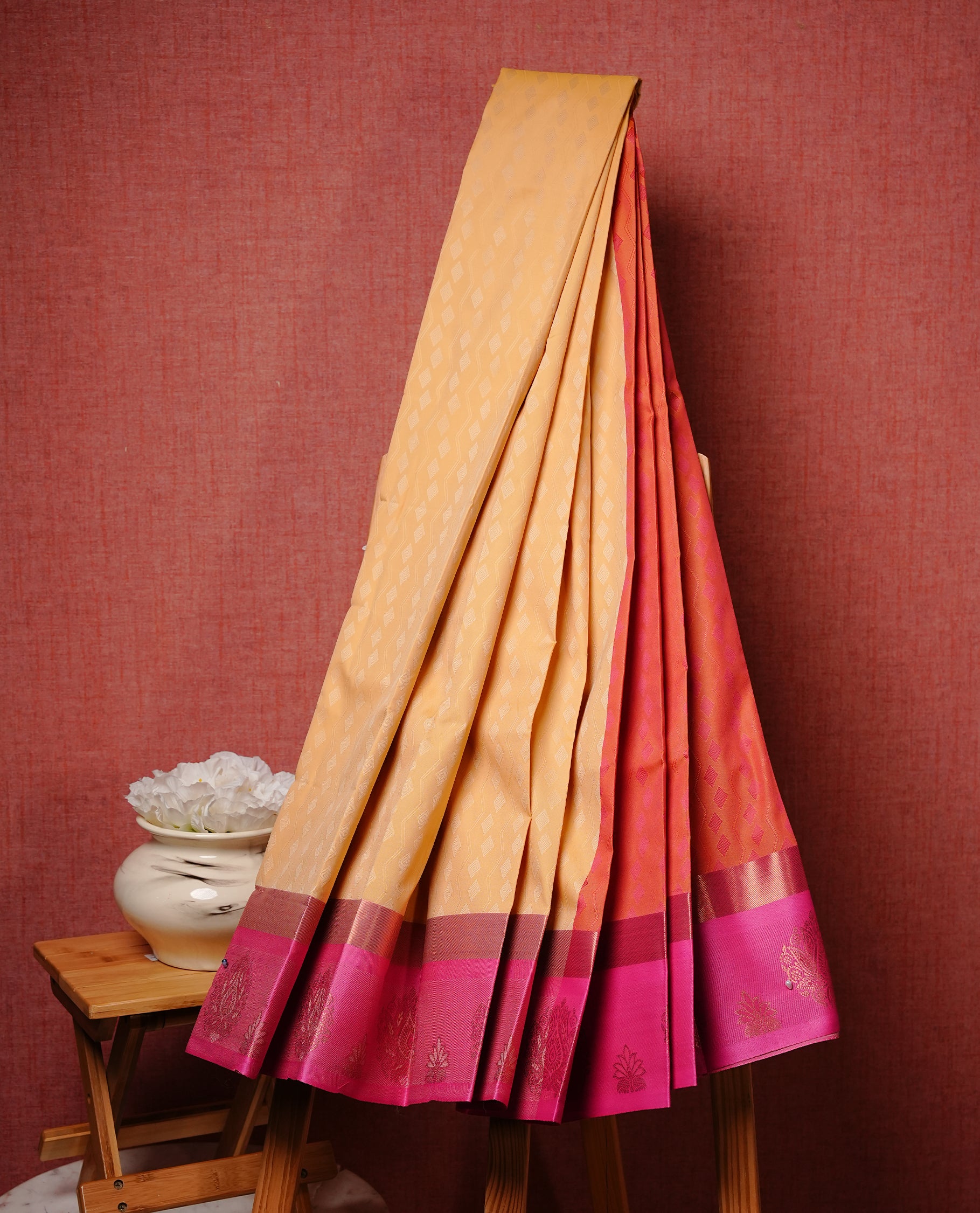 Pale yellow colour Semi silk saree featuirng Cream colour patterns on body, complemented by contrast magenta colour with gold zari border, paired with matching blouse piece.