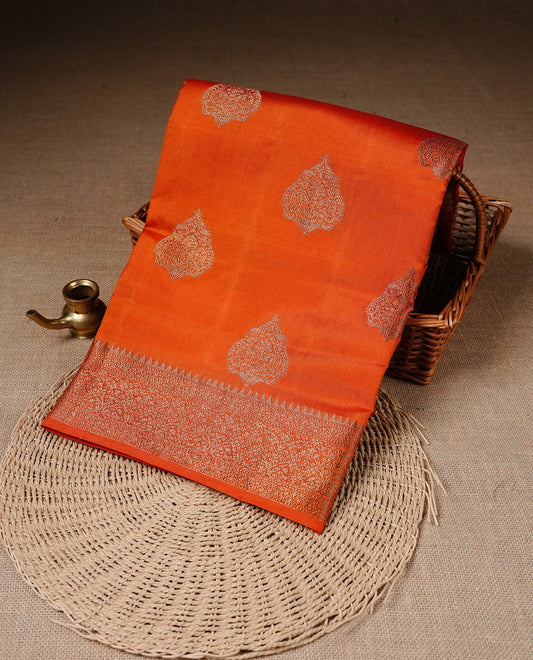Orange Colour Pure Banaras Soft Silk saree featuring Antique Zari buttas in body, complemented by zari work on self colour border, paired with matching Blouse Piece.