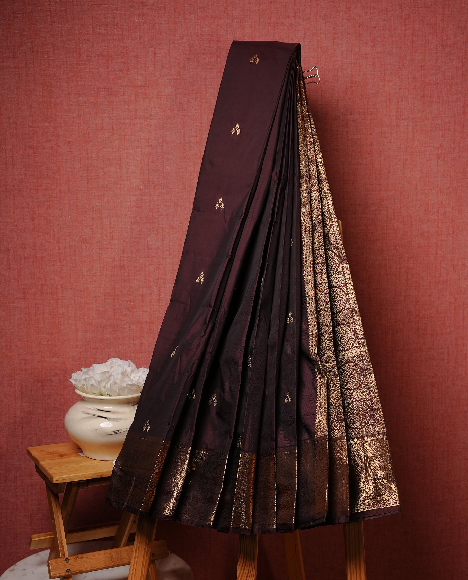 Dark chocolate colour Semi silk saree Featuring gold zari motifs on body, complemented by Self colour with gold zari border, paired with matching blouse piece.
