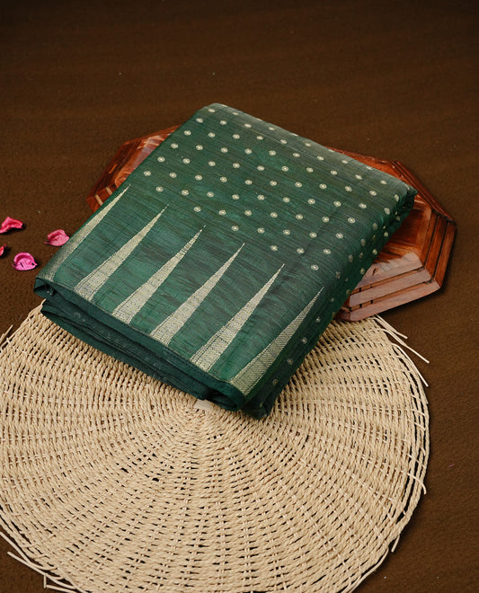 Green colour semi tussar silk saree featuring gold zari dot motifs all over the body, highlighted by a self colour border with intricate gold zari temple patterns. Comes paired with a matching blouse piece.