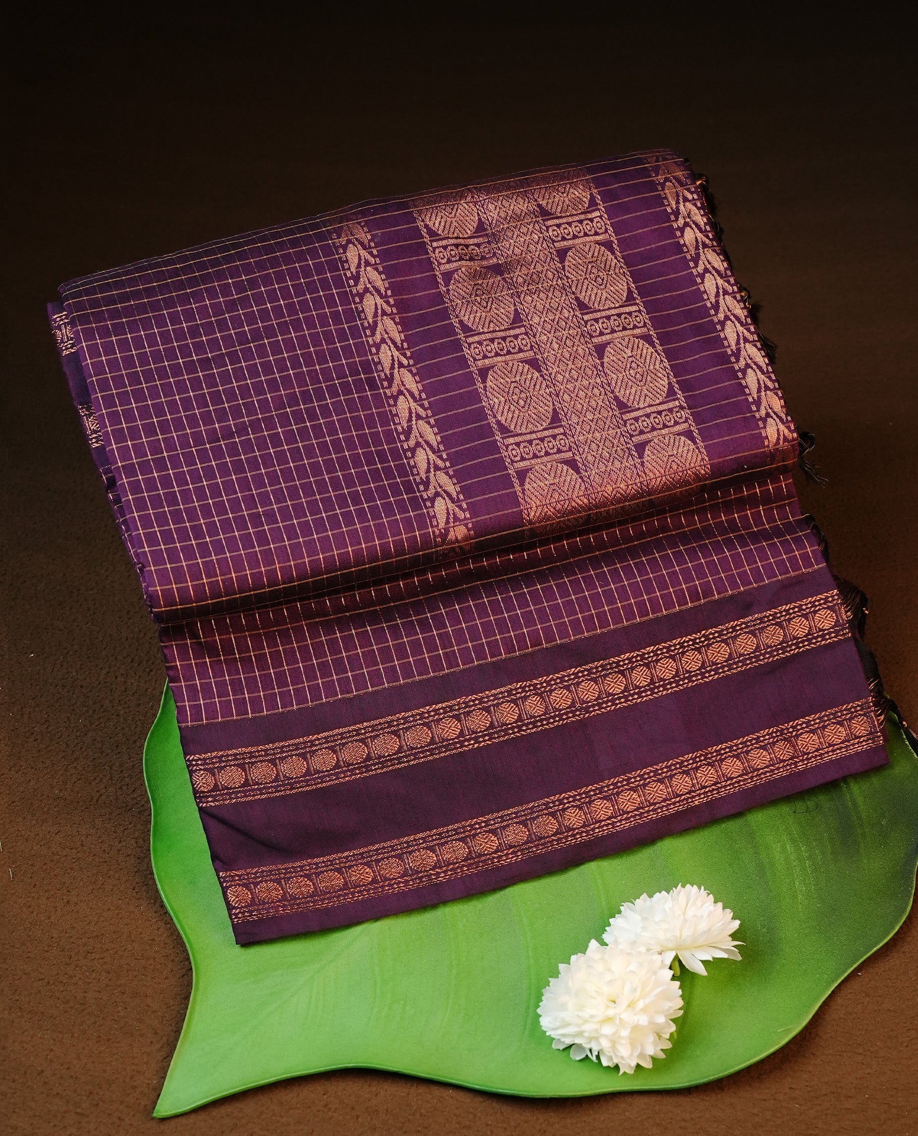 Grape colour kalyani cotton saree featuring gold zari Check pattern on body, complemented by self colour with Antique zari border, paired with matching blouse piece.