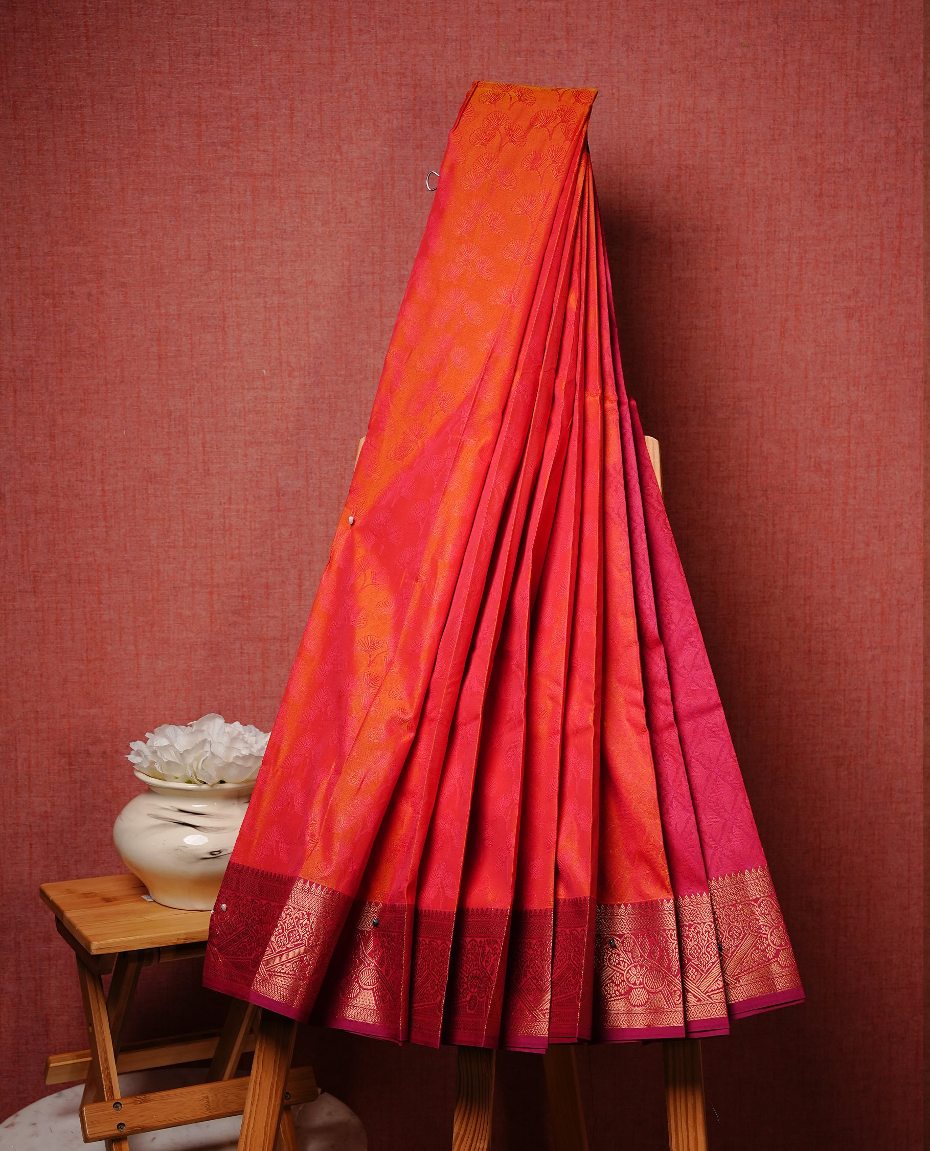 Orange colour Semi silk saree Featuring selfcolour zari motifs on body, complemented by contrast Magenta colour with gold zari border, paired with matching blouse piece.